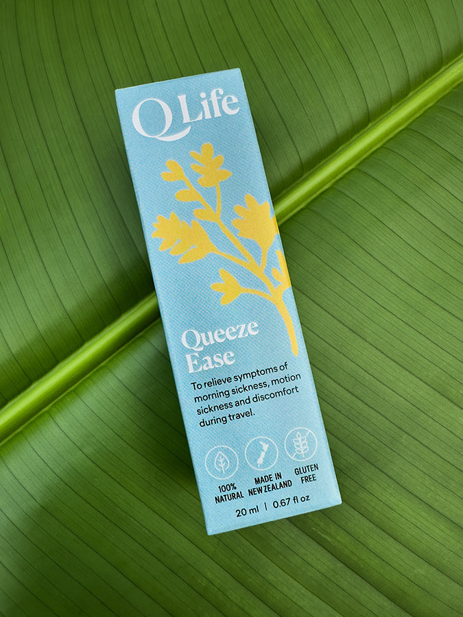 Q Life Queeze Ease box on a green leaf, highlighting the product's natural ingredients.