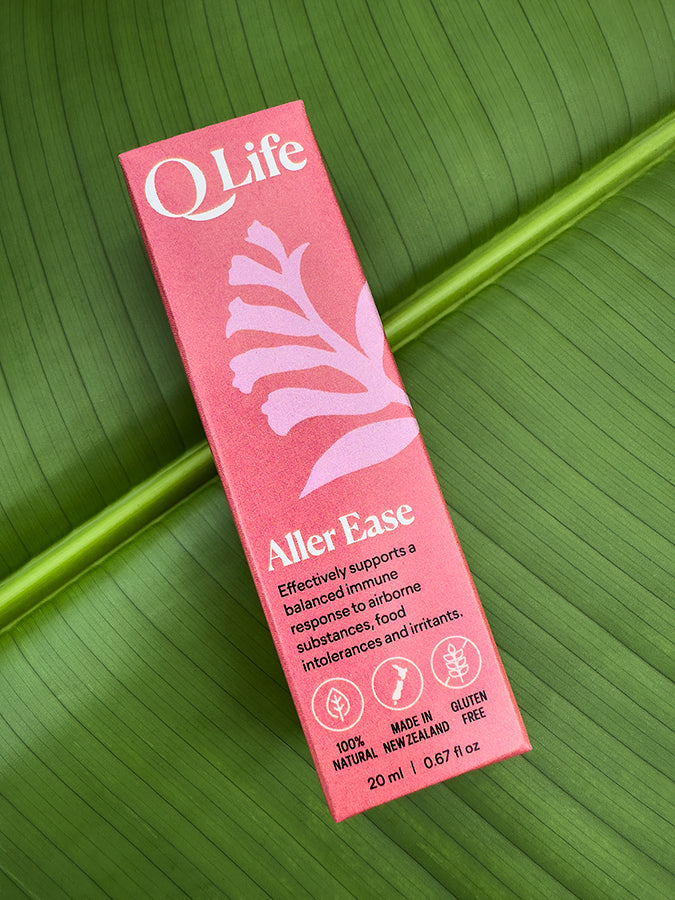 Q Life Aller Ease box on a green leaf, highlighting the product's natural ingredients.