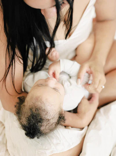 A baby crying and looking uncomfortable, representing an article about lactose overload in babies.